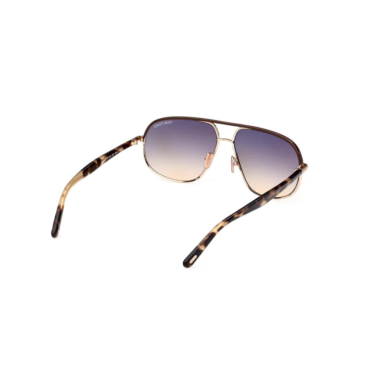 Sunglasses with tortoiseshell frame and gradient lenses on a white background