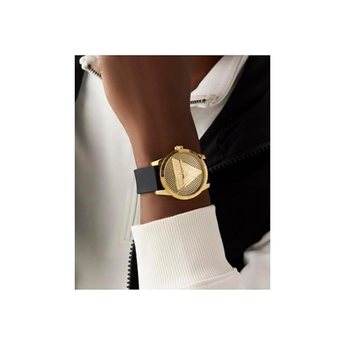 Gold watch with black strap on a wrist against a white background