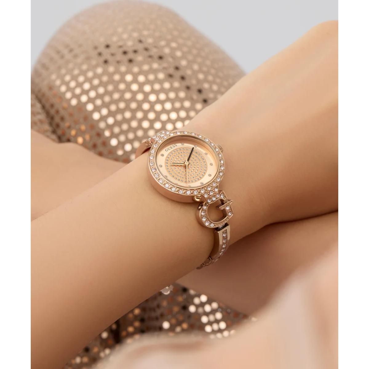 Rose gold watch with diamond accents on a wrist against a neutral background