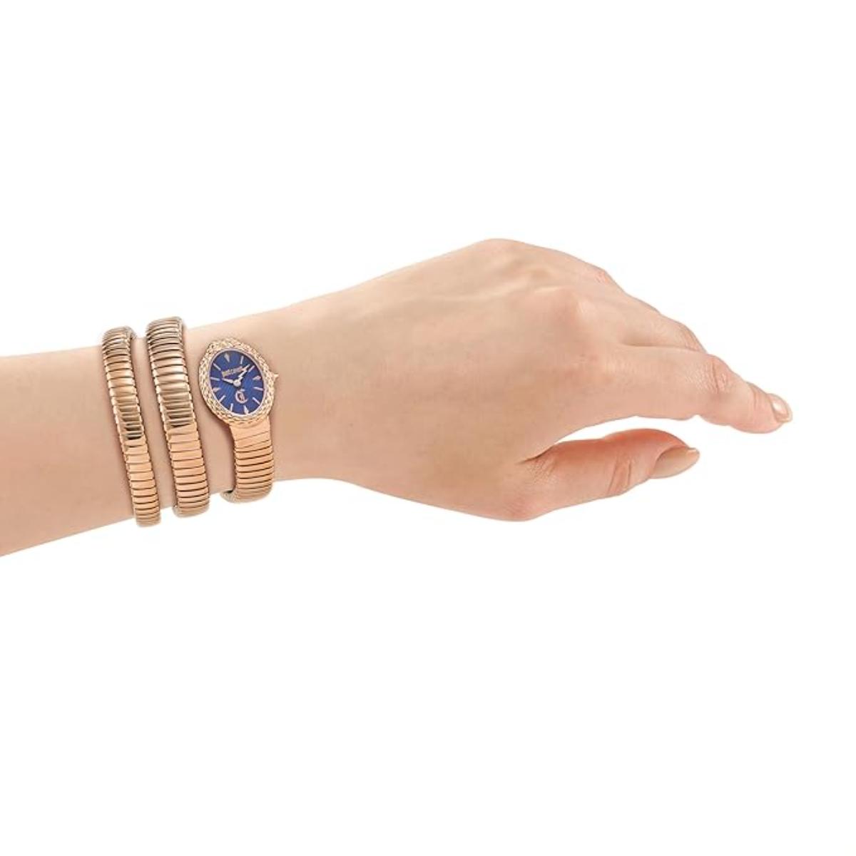 Hand wearing a rose gold watch and bracelets on a white background