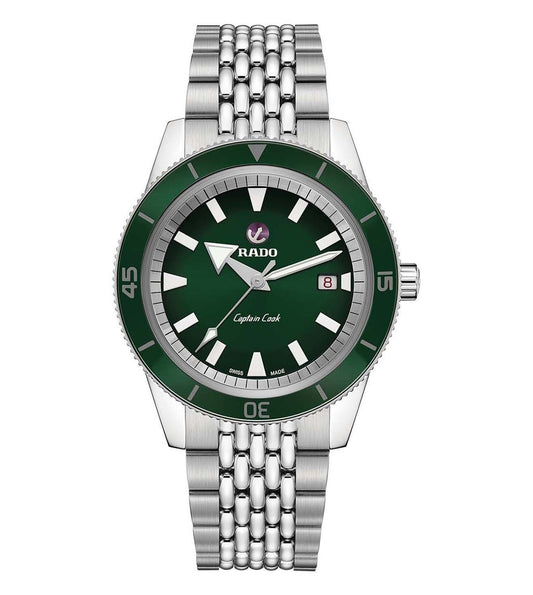 A silver Rado Captain Cook automatic watch with a green dial and date display, accompanied by a metal bracelet.