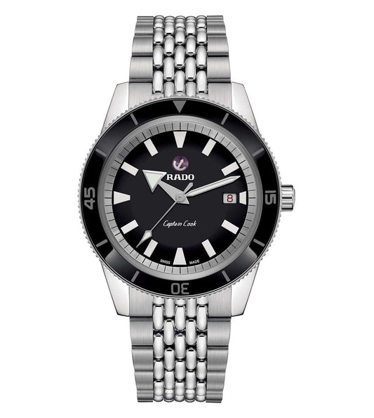 A Rado Captain Cook Automatic watch for men with a black dial, silver stainless steel bracelet, and black casing.
