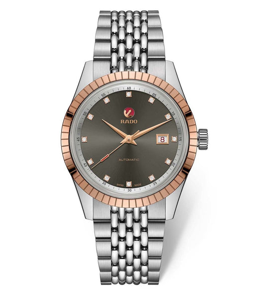 A Rado HyperChrome Classic Golden Horse automatic watch with a rose gold-colored case and a silver bracelet, featuring a dark dial with diamond markers and a date display.