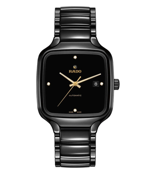 A black Rado True Square Automatic Diamonds watch with a square face, gold hands and markers, and a date display, on a matching black bracelet.