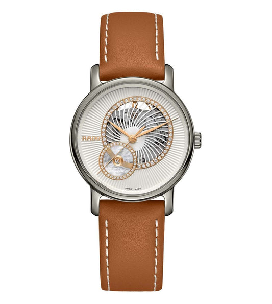 A Rado DiaMaster Automatic Open Heart Diamonds watch with a brown leather band and silver-colored dial, featuring diamond accents.