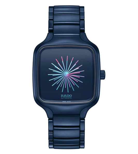 A blue Rado True Square Multifunction Unisex Watch with a colorful burst pattern on the dial and a metallic bracelet.
