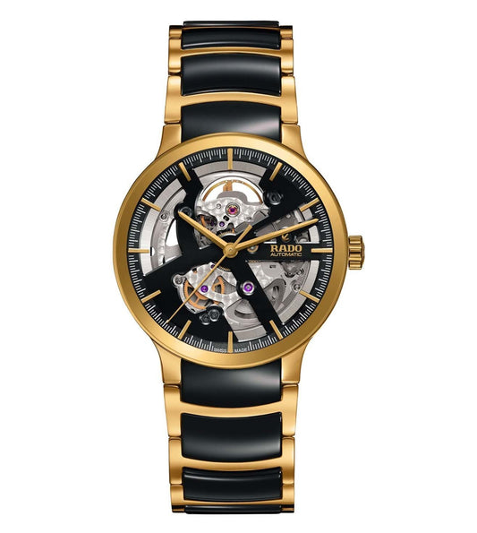 A Rado Centrix Automatic Open Heart Unisex Watch with a black and gold color scheme, featuring a transparent case back showcasing the automatic movement.