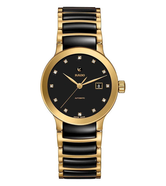 A Rado Centrix Automatic watch for women with a black dial adorned with diamond markers, set in a gold case, and a gold bracelet.