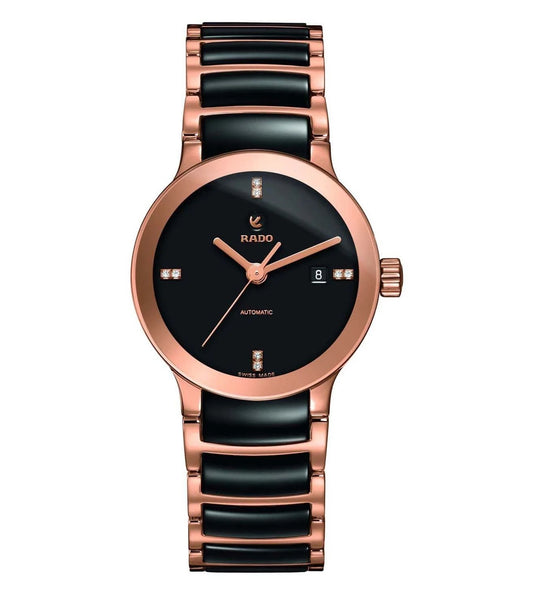 A Rado Centrix Automatic watch for women with a black dial, rose gold case and bracelet, and diamond markers.