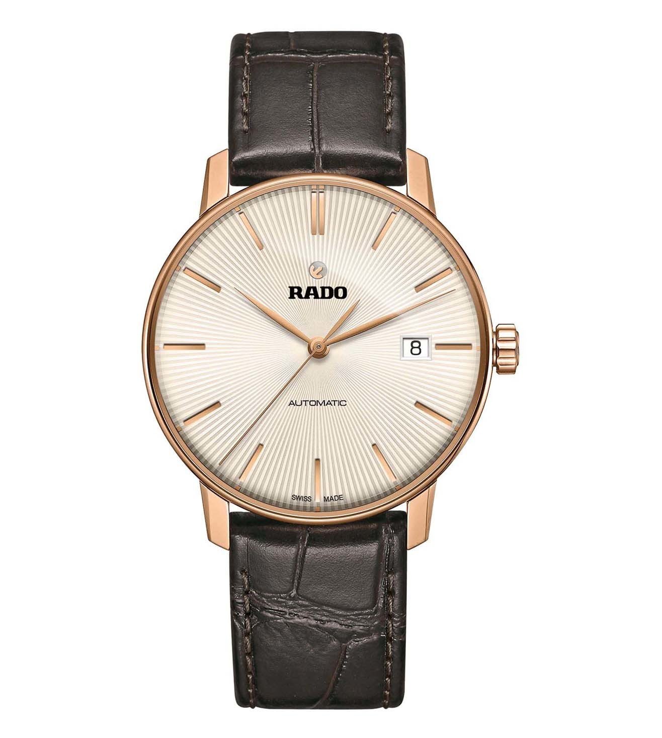 A Rado Coupole Classic Automatic watch with a rose gold case, a beige dial, and a brown leather strap.