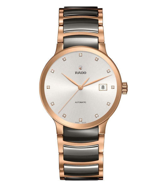 A Rado Centrix Automatic watch for men with a silver dial, rose gold case, and a two-tone rose gold and silver bracelet.