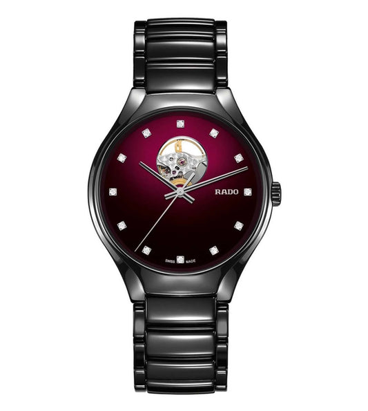 A Rado New True Analog Unisex Watch with a deep red dial, diamond numerals, and a black bracelet.