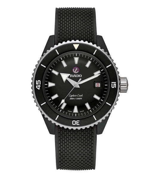 A black RADO Captain Cook analog watch with a ceramic case, stainless steel bezel, and a black rubber strap. The dial is black with white indices and a date display.