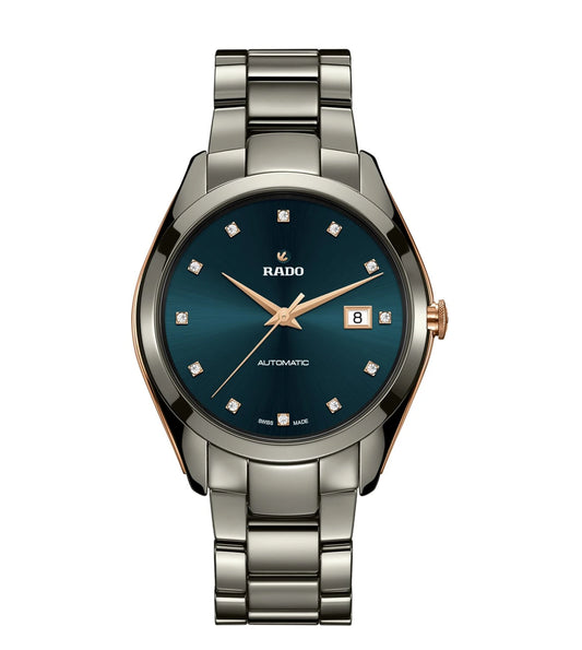 A Rado HyperChrome Automatic Diamonds watch with a dark turquoise dial, rose-goldicolored hands, and a stainless steel bracelet.