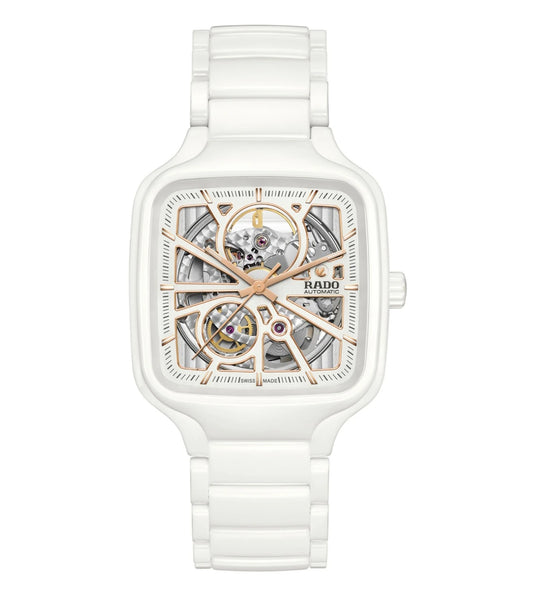 A white ceramic Rado True Square Open Heart Automatic unisex watch with a rose gold skeleton dial and a white bracelet.