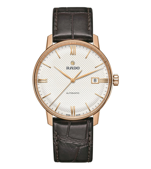 A Rado Coupole Classic Automatic Unisex Watch with a rose gold case, white dial, and brown leather strap.