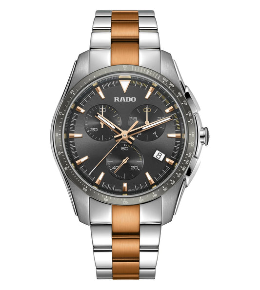 A Rado Hyperchrome Chronograph watch with a dark grey dial, rose gold hands and indexes, and a two-tone bracelet with polished stainless steel and rose gold brushing.