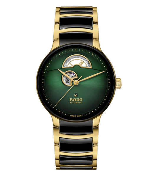 A Rado Centrix Automatic Open Heart Unisex Watch with a green to black gradient dial, yellow gold colored hands, and a bracelet with polished yellow gold colored stainless steel and black high-tech ceramic links.