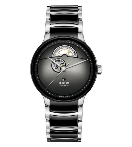 A Rado Centrix Automatic Open Heart Unisex Watch with a silver to black gradient dial, rhodium colored hands, and a polished stainless steel and black high-tech ceramic bracelet.