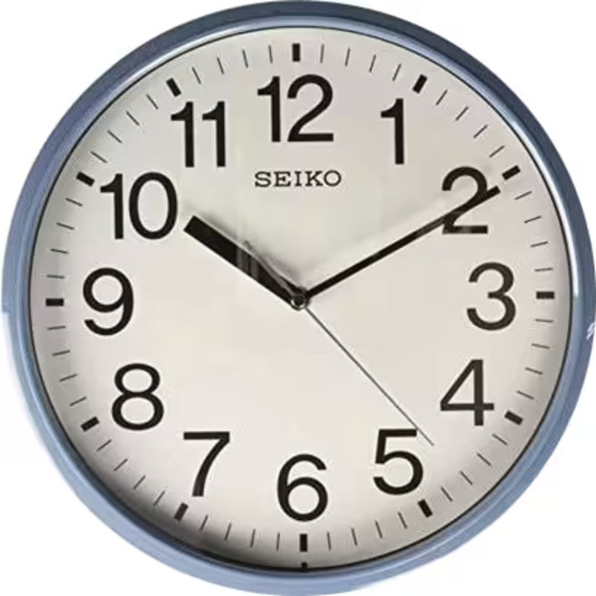 Seiko wall clock with a white face and blue rim on a white background