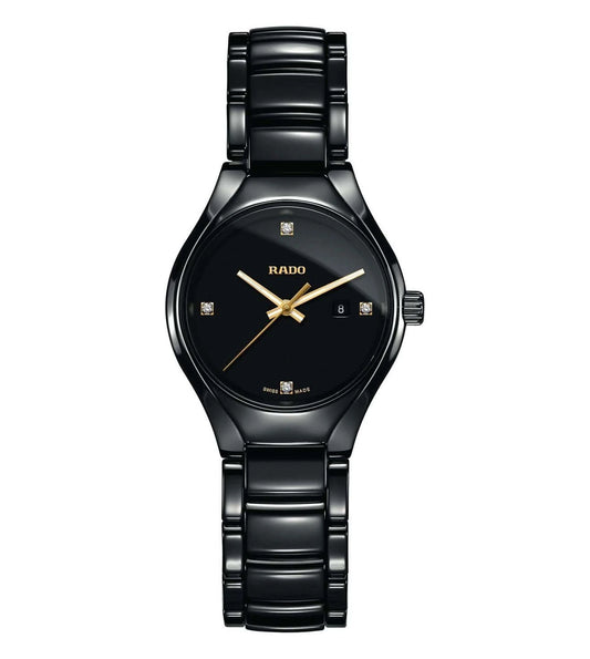 A black Rado True watch for women with a black band and dial, featuring gold hands and diamond accents.