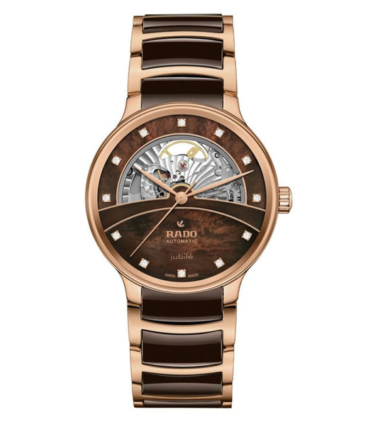 A Rado Centrix Automatic Diamonds Open Heart watch with a rose-gold case, a brown mother-of-pearl dial, and a transparent case back showing the automatic movement.