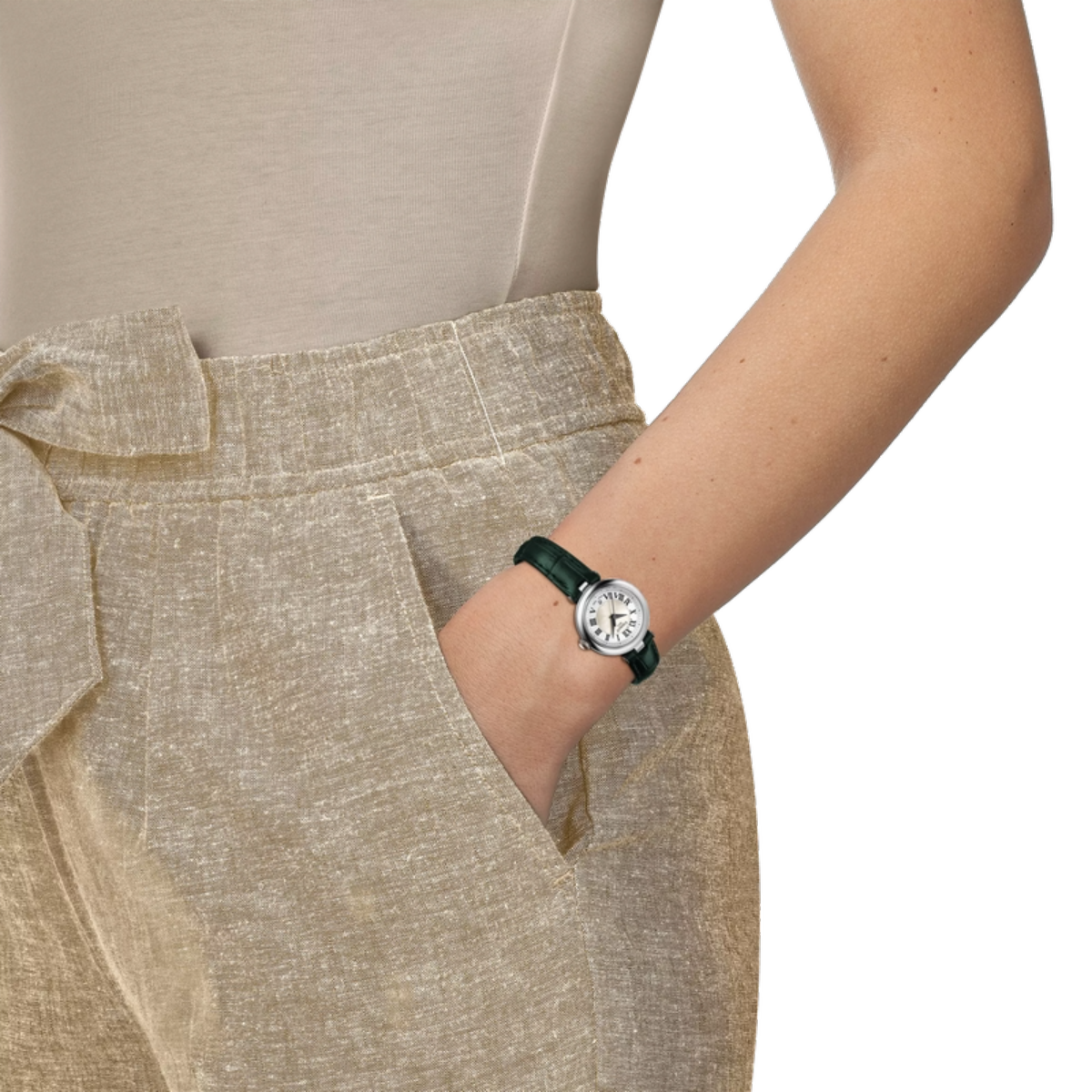 Person wearing a beige outfit with a watch on a white background