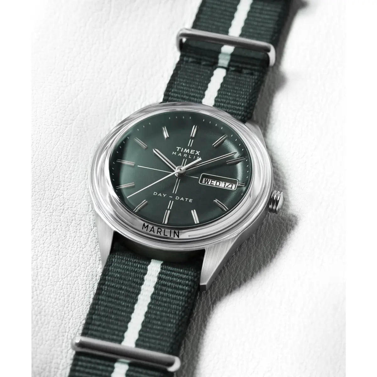 Timex watch with green strap and dark green face on a white background