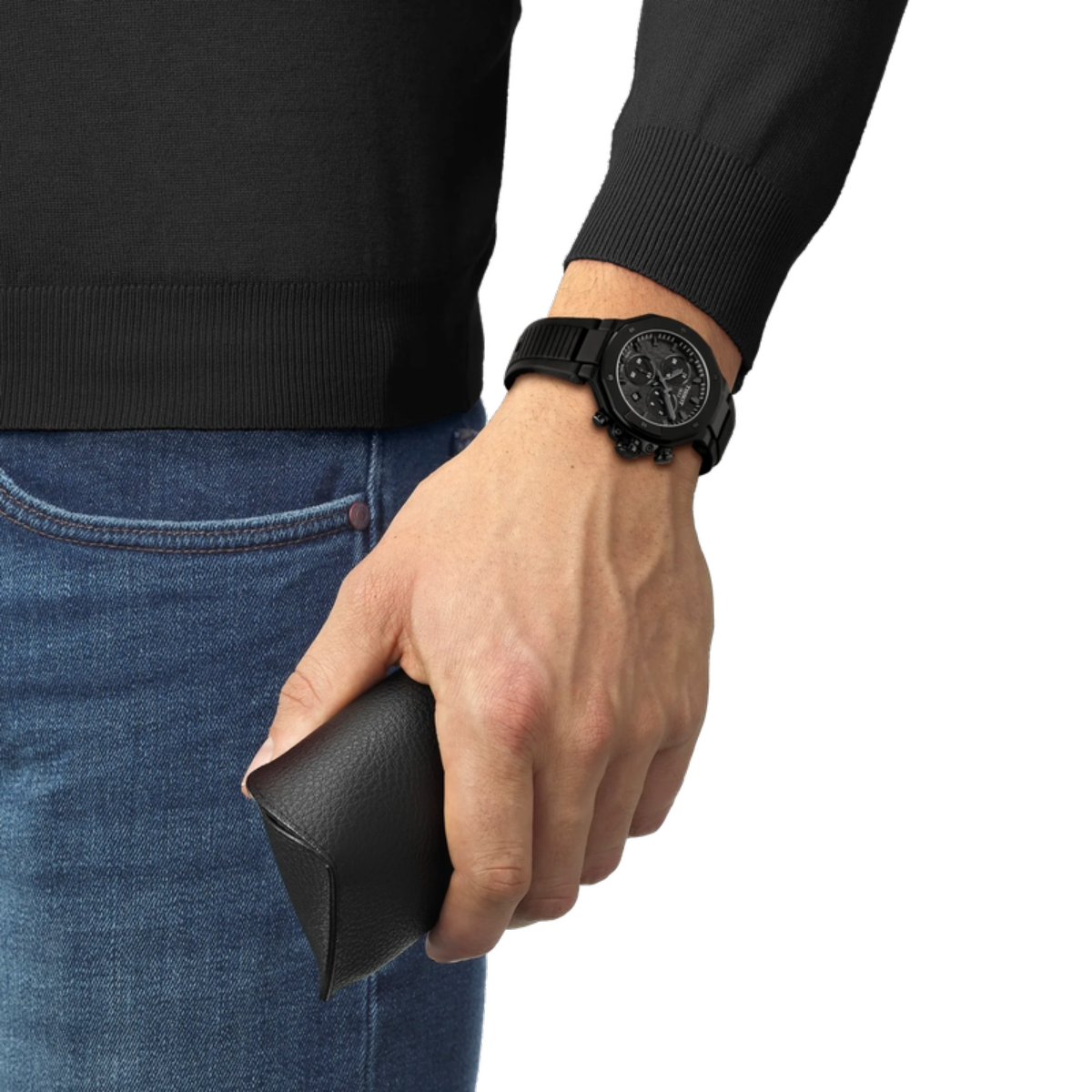 Hand wearing a black watch holding a black wallet, with a plain background