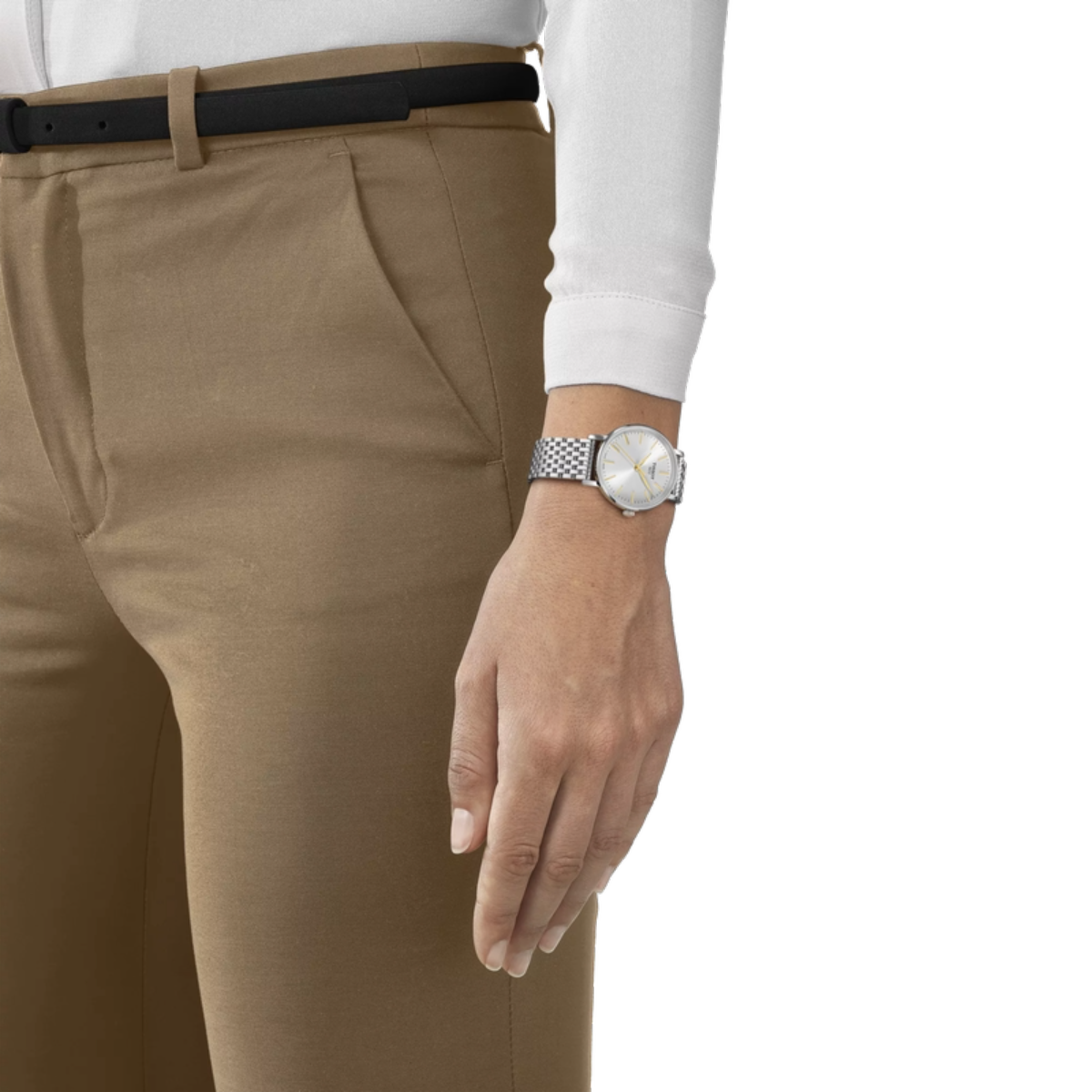 Person wearing beige pants and a white shirt with a watch on a white background