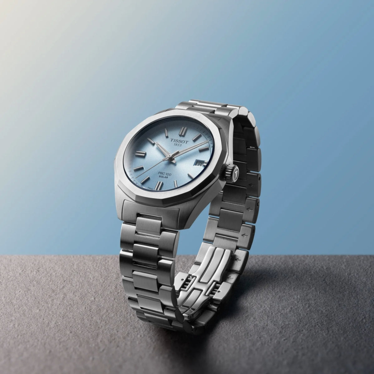Silver watch with a blue face on a gradient background