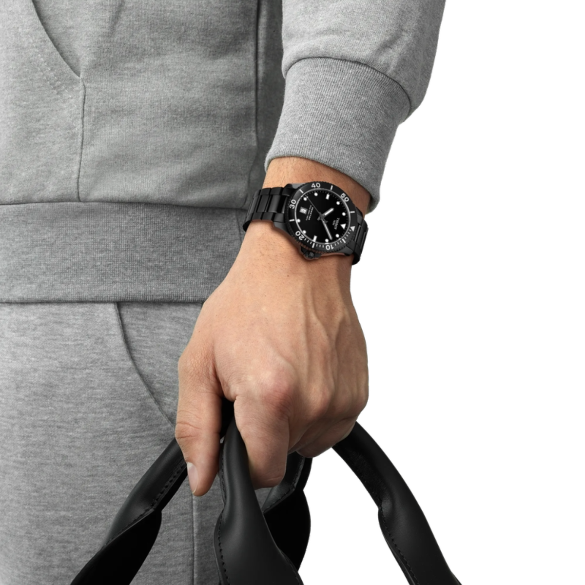 Person wearing a black watch on a gray background