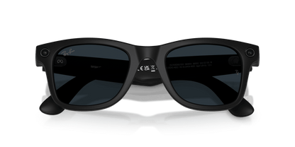 Black sunglasses on a gray stand with a blue gradient background