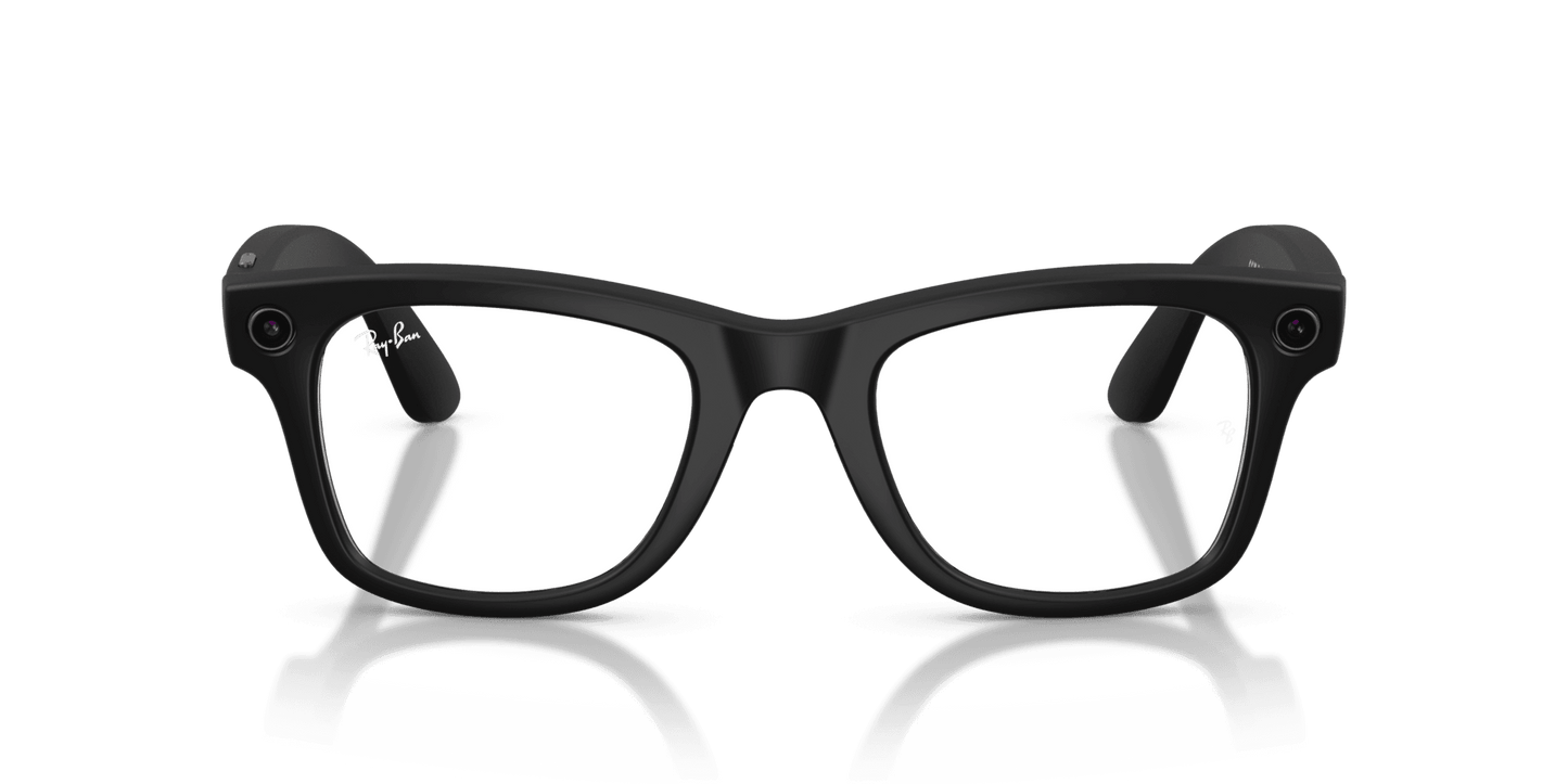 Black glasses on a reflective surface with a dark green background