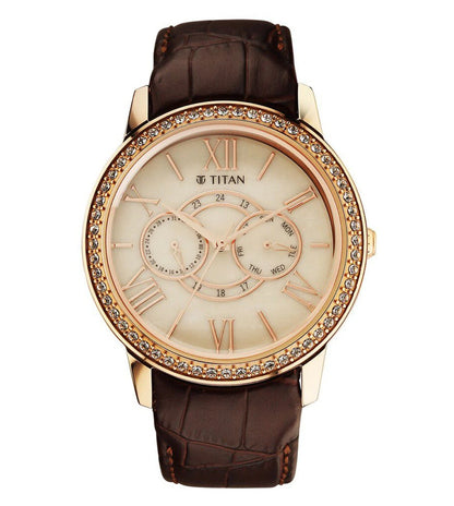 A TITAN Regallia analog watch for men with a beige dial, stainless steel case, and a brown leather strap.