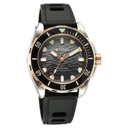A Titan automatic watch with a black textured dial, black rubber strap, and a two-tone silver and rose gold case and bezel.