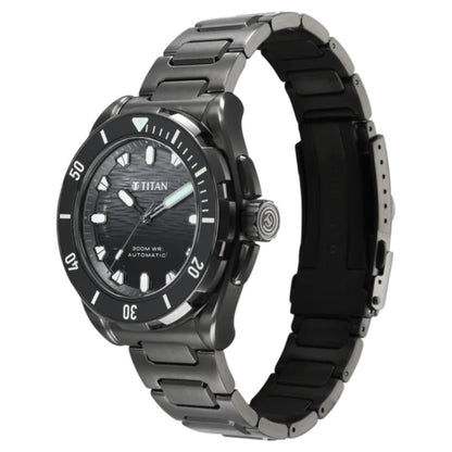 A titanium analog watch with a dark gray and black metal link bracelet, a black textured dial, and a black bezel with white hour markers.