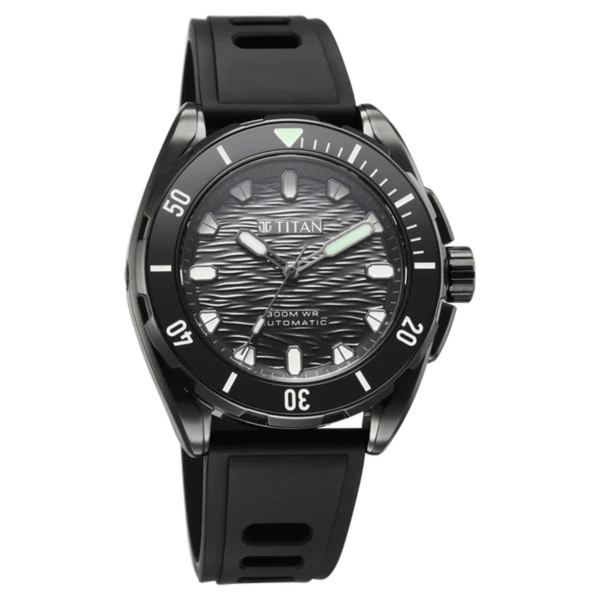 A Titan brand automatic watch with a black bezel, textured black dial, and black strap, shown against a plain white background.