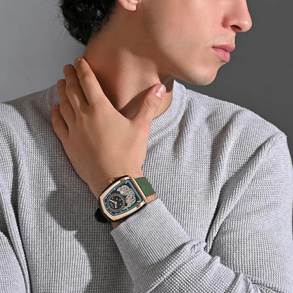 Person wearing a watch with a detailed face, dressed in a gray sweater.