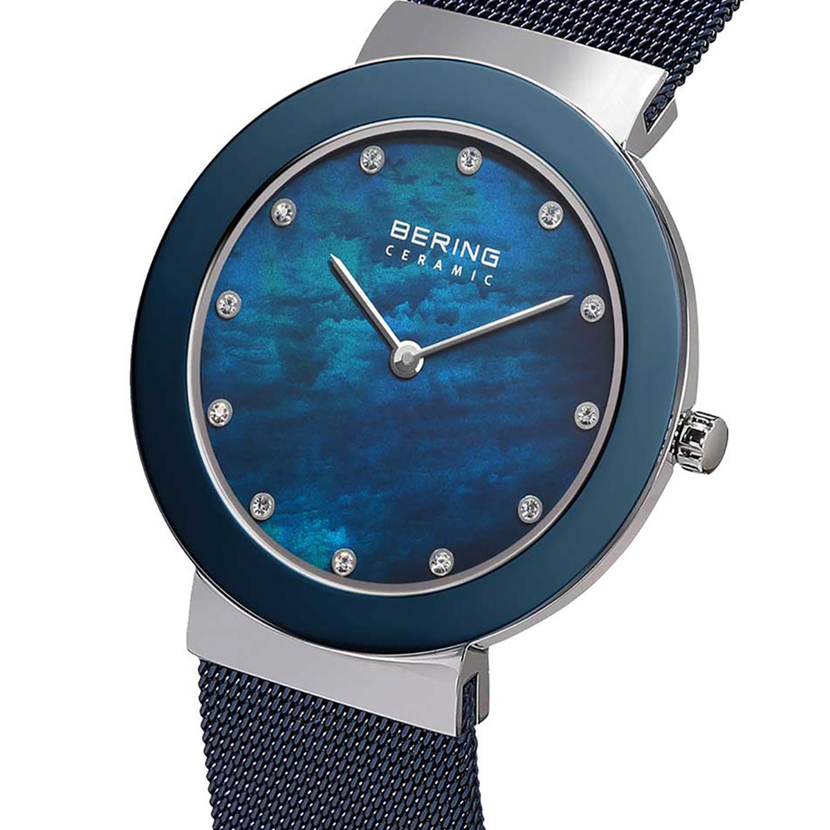 Bering watch with blue face and mesh band on a white background
