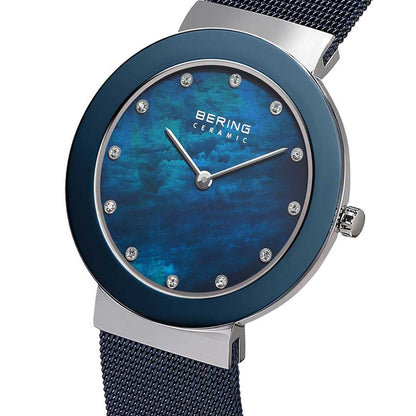 Bering watch with blue face and mesh band on a white background