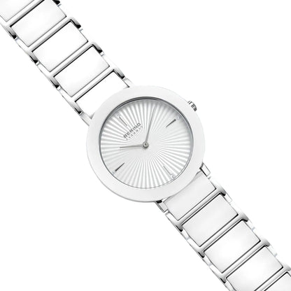Silver watch with a detailed face on a light gray background