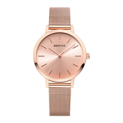 Rose gold watch with mesh band on a white background