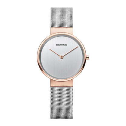 Bering watch with rose gold case and silver mesh band on a white background