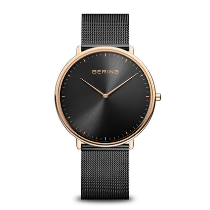 Black watch with rose gold bezel and mesh band on white background