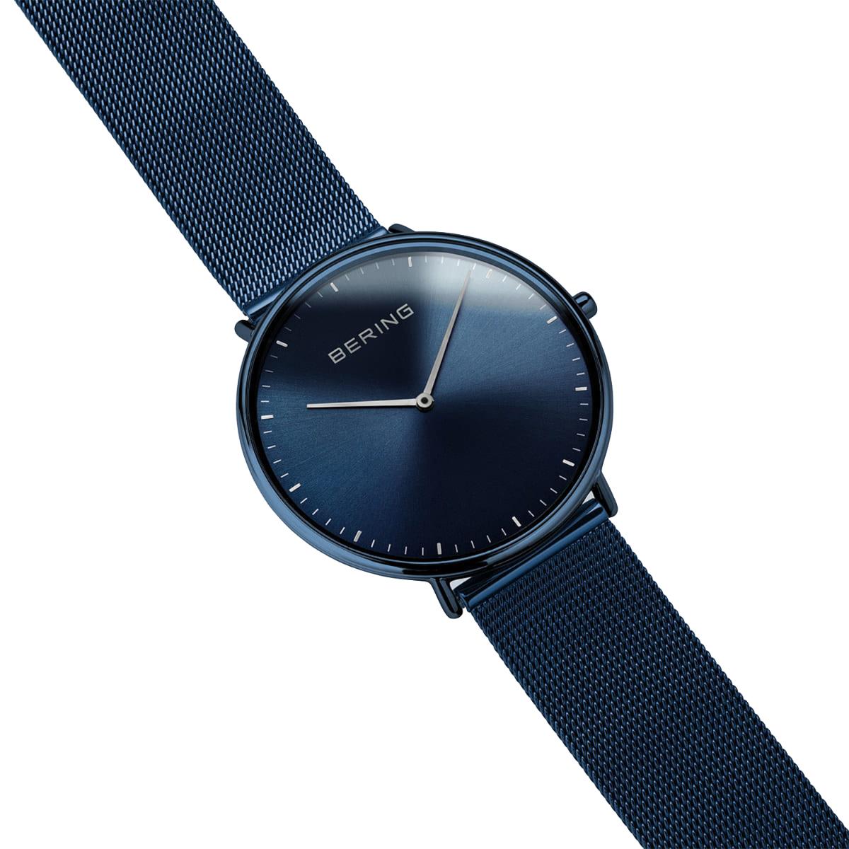 Blue watch with mesh strap on a white background