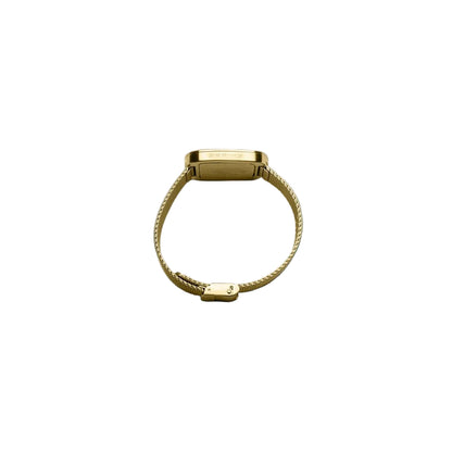 Gold bracelet on a light blue background