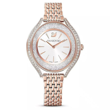 Rose gold Swarovski watch with a white face on a white background