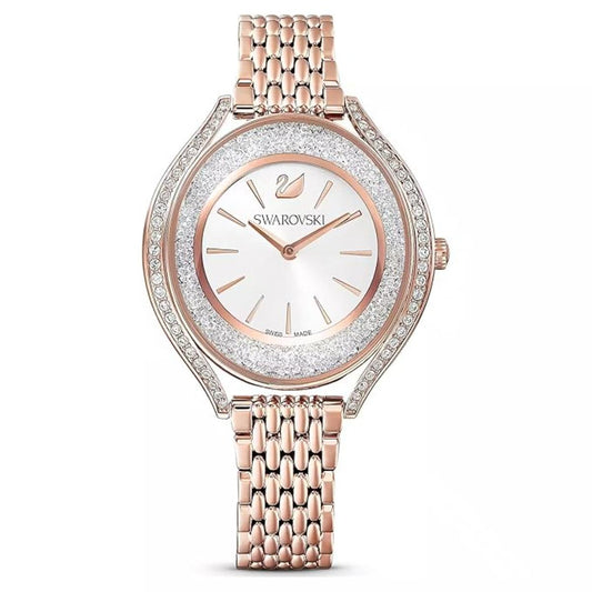 Rose gold Swarovski watch with a white face on a white background