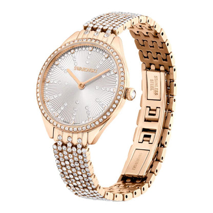 Rose gold Swarovski watch with diamond-studded bracelet on a white background